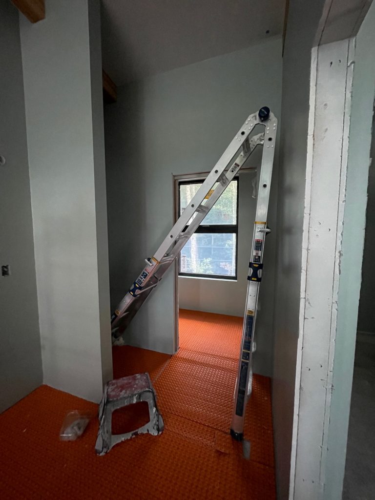 Ladder leaning against wall for painting