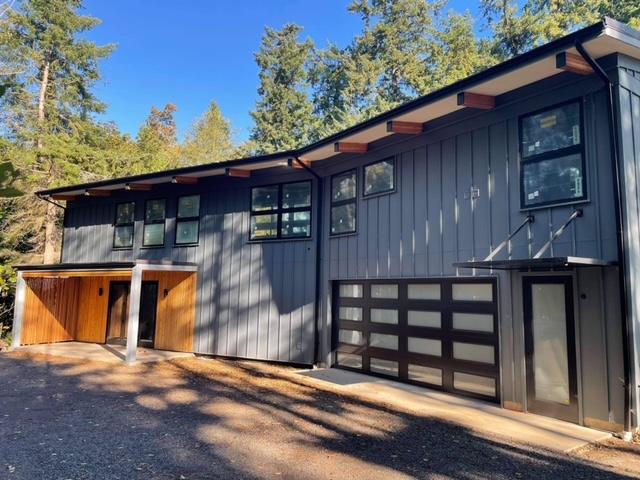 Exterior view of house showing new garage door