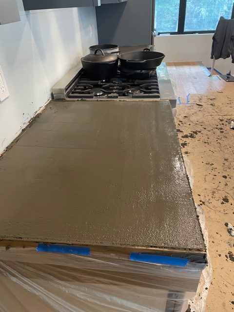 Wet concrete curing on side countertop