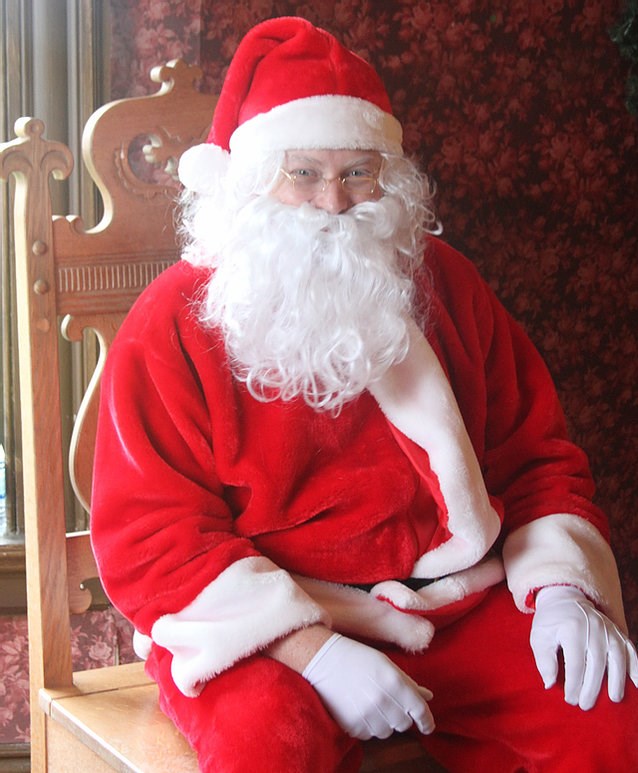Santa Claus in red suit sitting in a chair